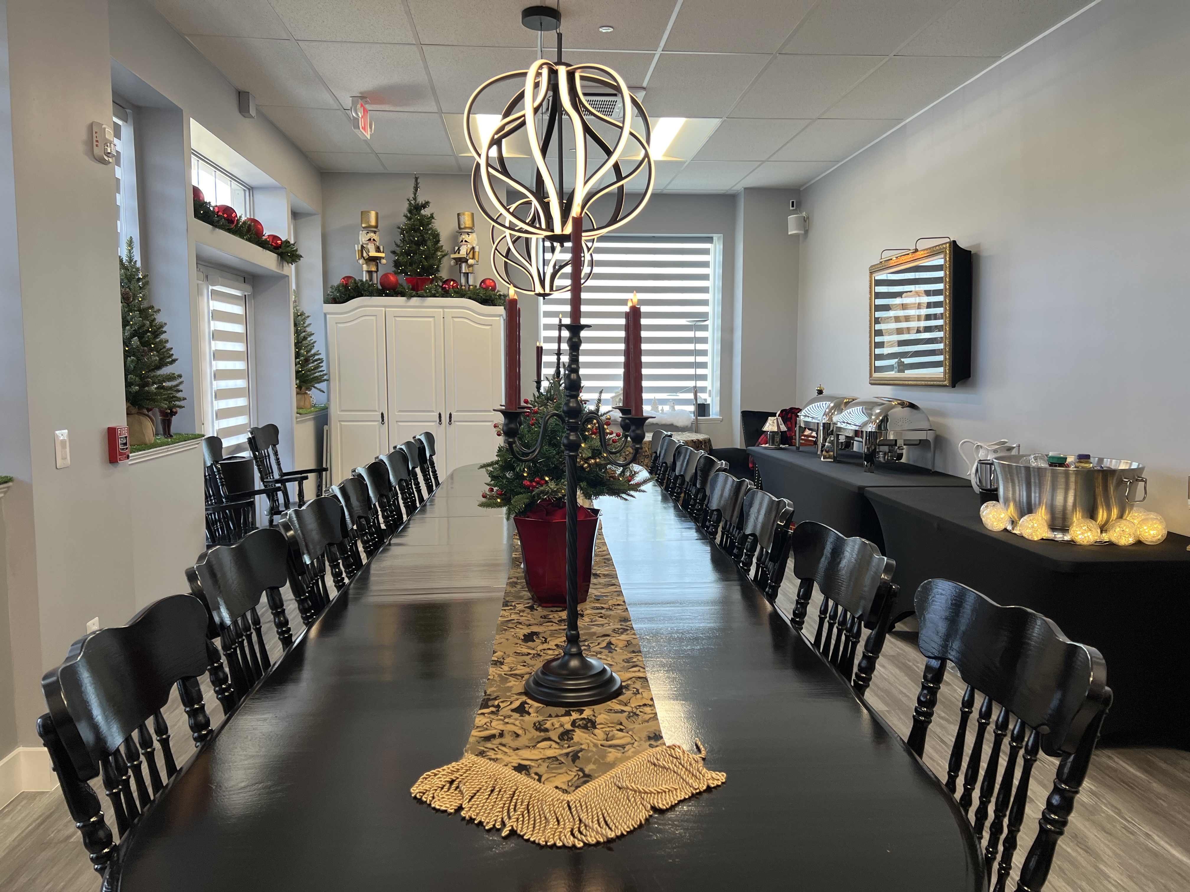 banquet room with large oval table with 24 tables around it