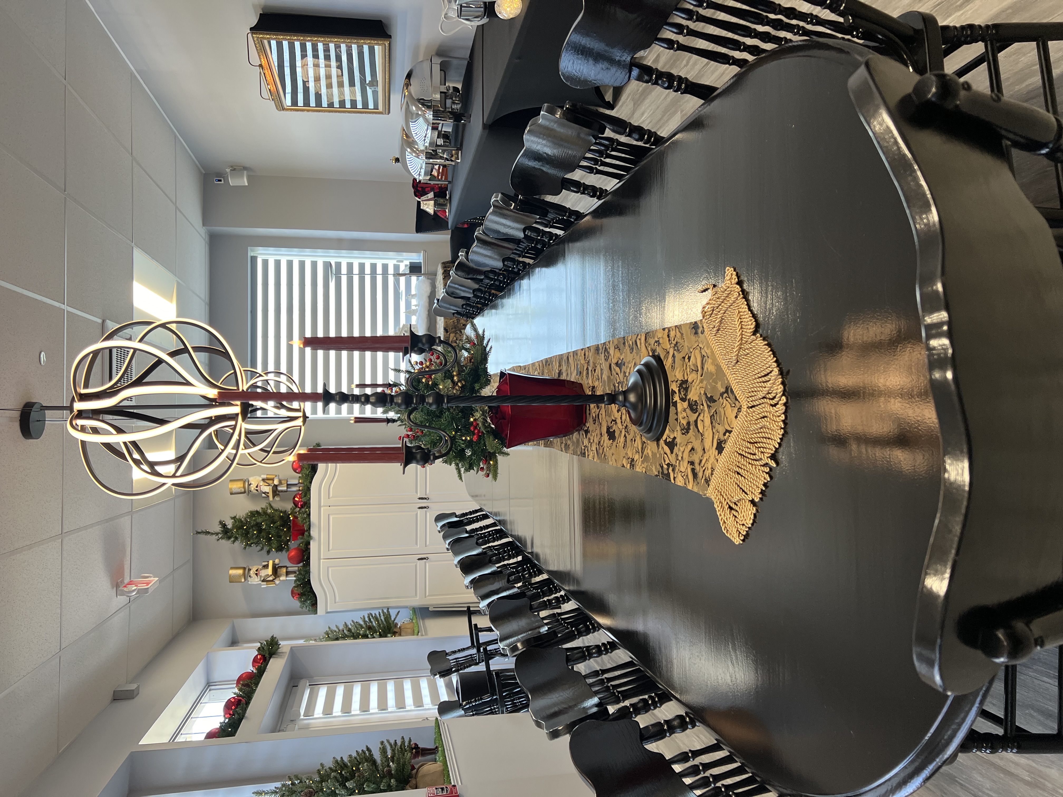 a tablecloth-covered meeting room table set with crystal glasses, china, and silverware.
