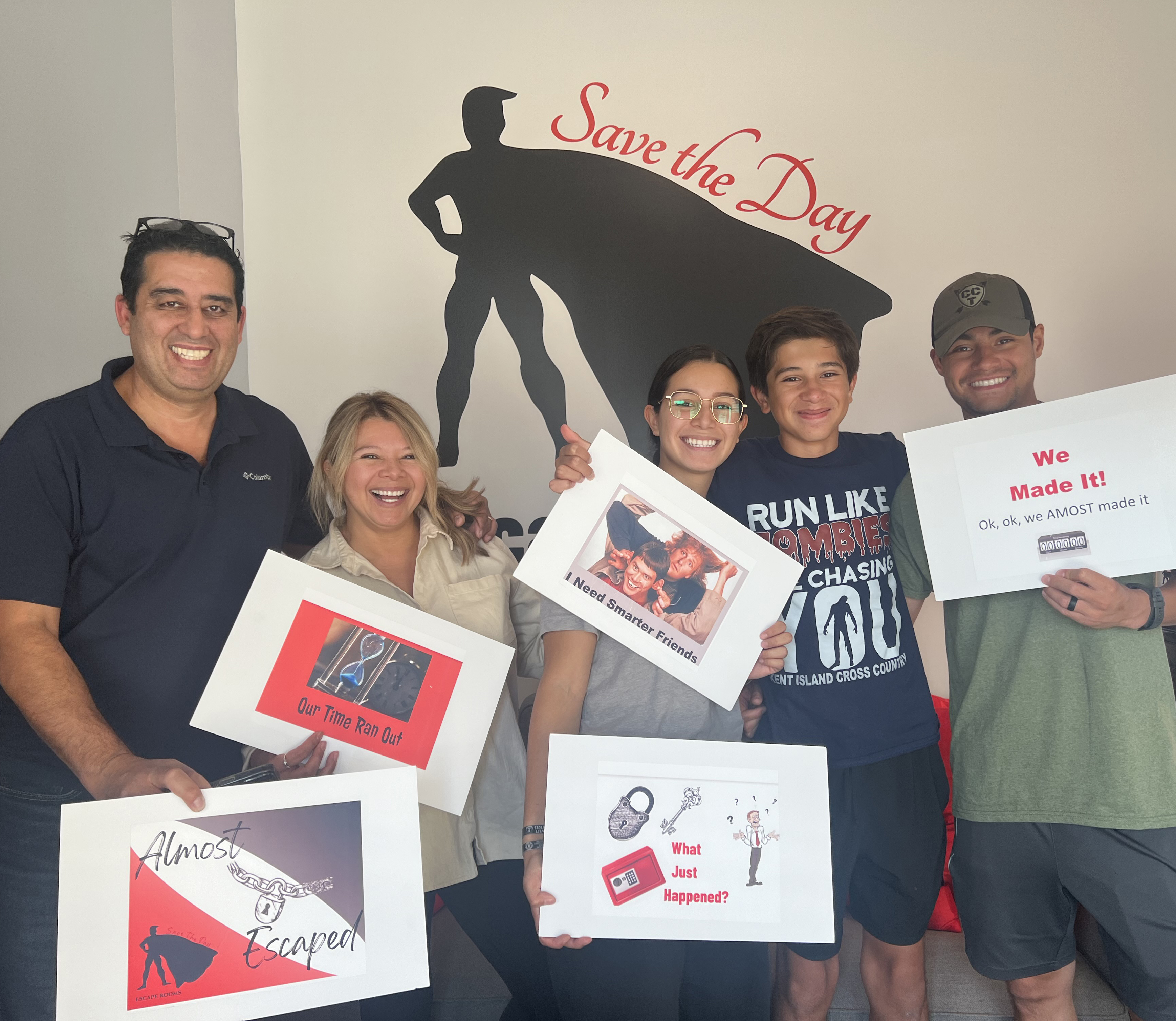 family of 5 holding signs signifying an escape room loss
