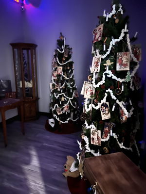 Christmas Carol Escape Room dimly light only light coming from lit Christmas tree