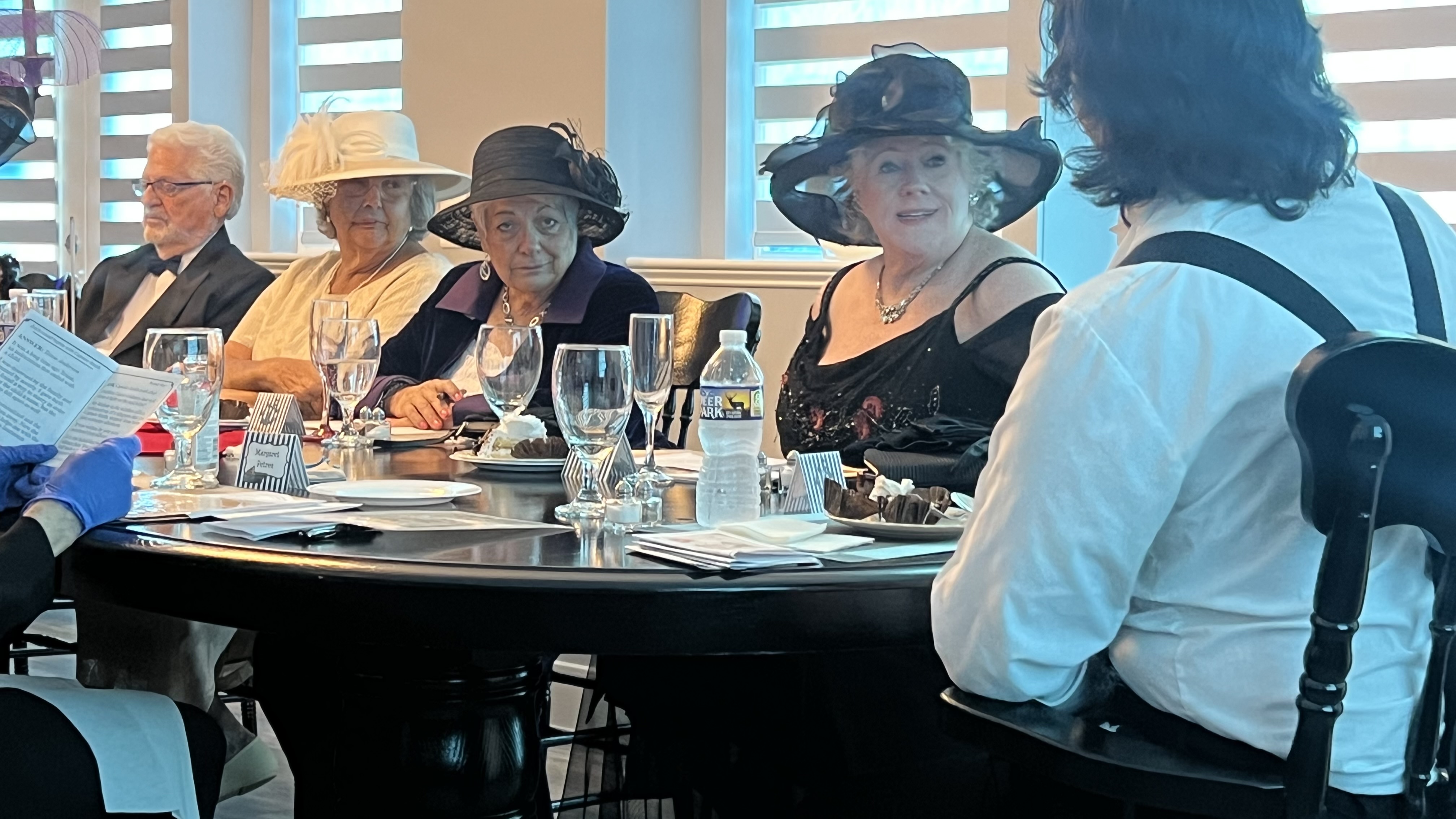People seated around a long table conversing with each other