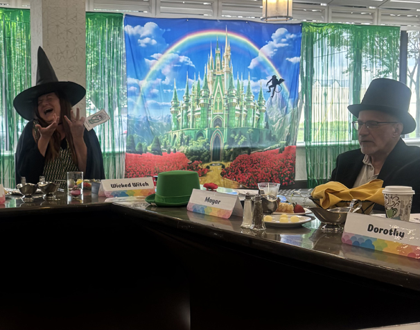 a seated wicked witch cackling