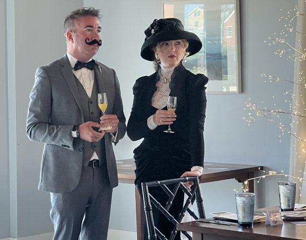 a woman and man dressed in formal early 1900's attire